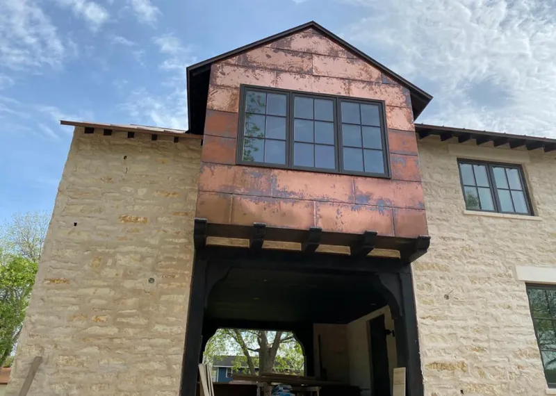 Copper metal panel facade on a stone building for Metal Roof Coating in Rifle