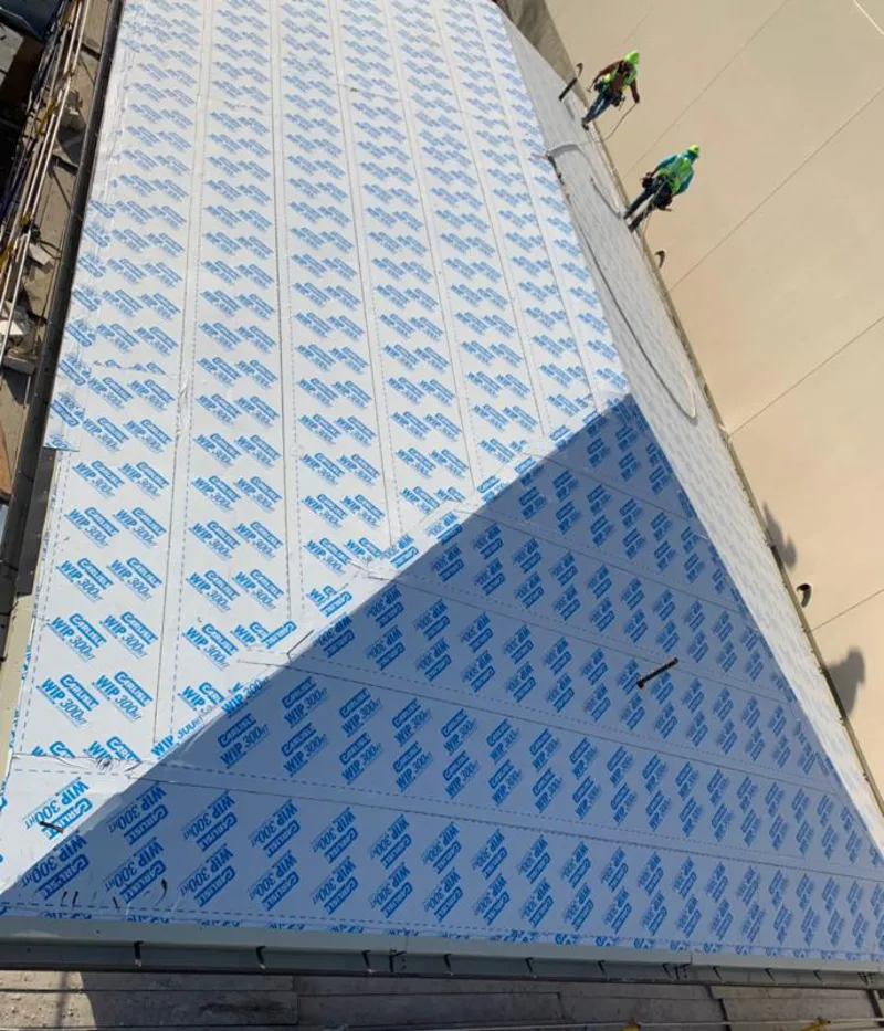 Professional roofers installing underlayment on a metal roof in Rifle